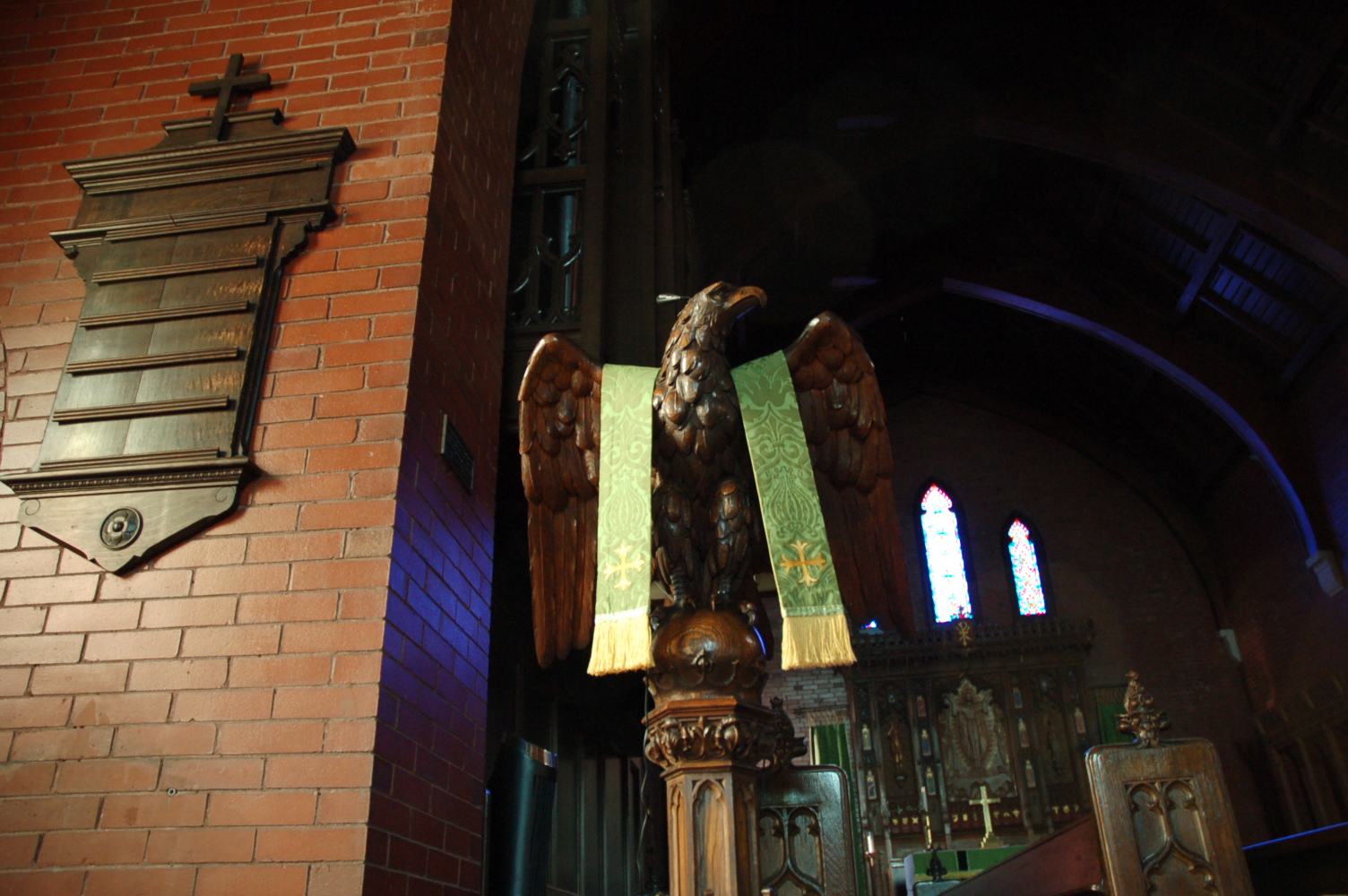 view from below of carved-eagle lectern with chancel behind