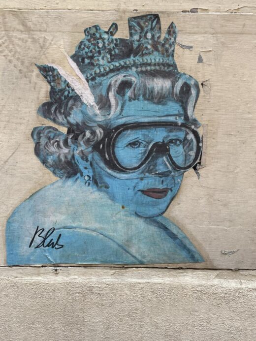 a piece of "altered art" that depicts Queen Elizabeth II of the UK in blue and wearing a diving mask. Artist: Blub