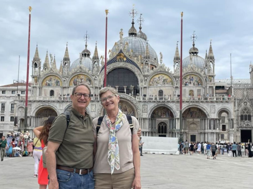 a couple poses in front of St Mark's Basilica, Venice, Italy