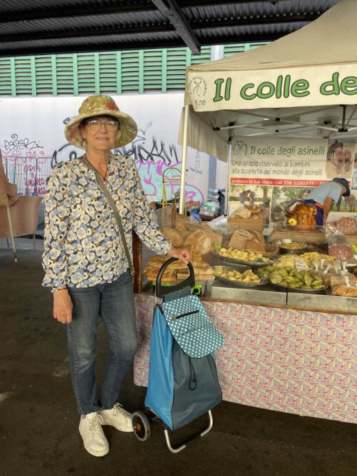 woman standing in front of a market vendor