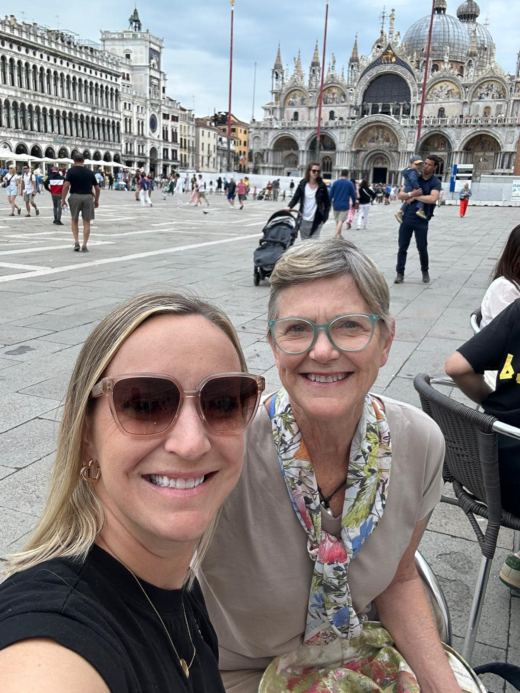 two women pose in a famous European city square
