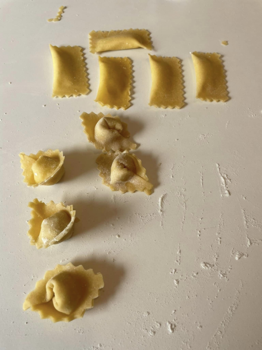 homemade pastas on a white surface with some flour