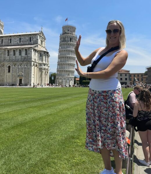 a woman pretending to prop up the Leaning Tower of Pisa
